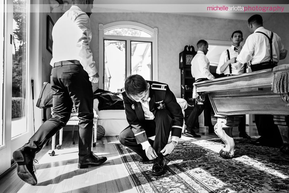 groom in military ties his shoes for New Jersey ryland inn wedding