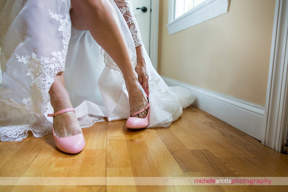 bride puts on pink wedding shoes nj