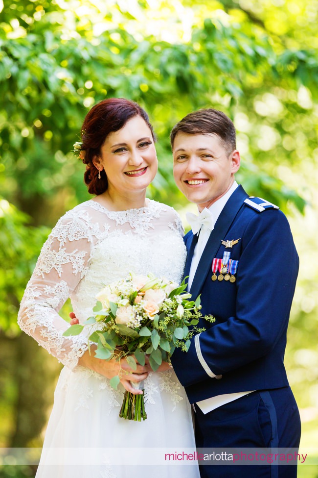 New Jersey bride in lacy dress laughs with groom in Air Force uniform ryland inn