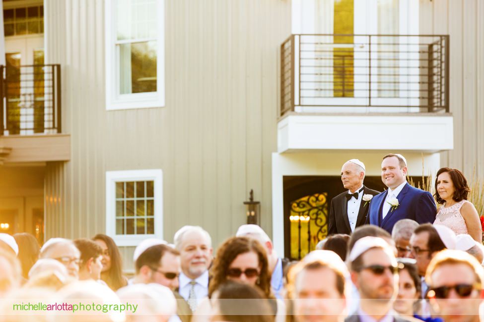 groom walks with parents down the aisle at New Jersey wedding