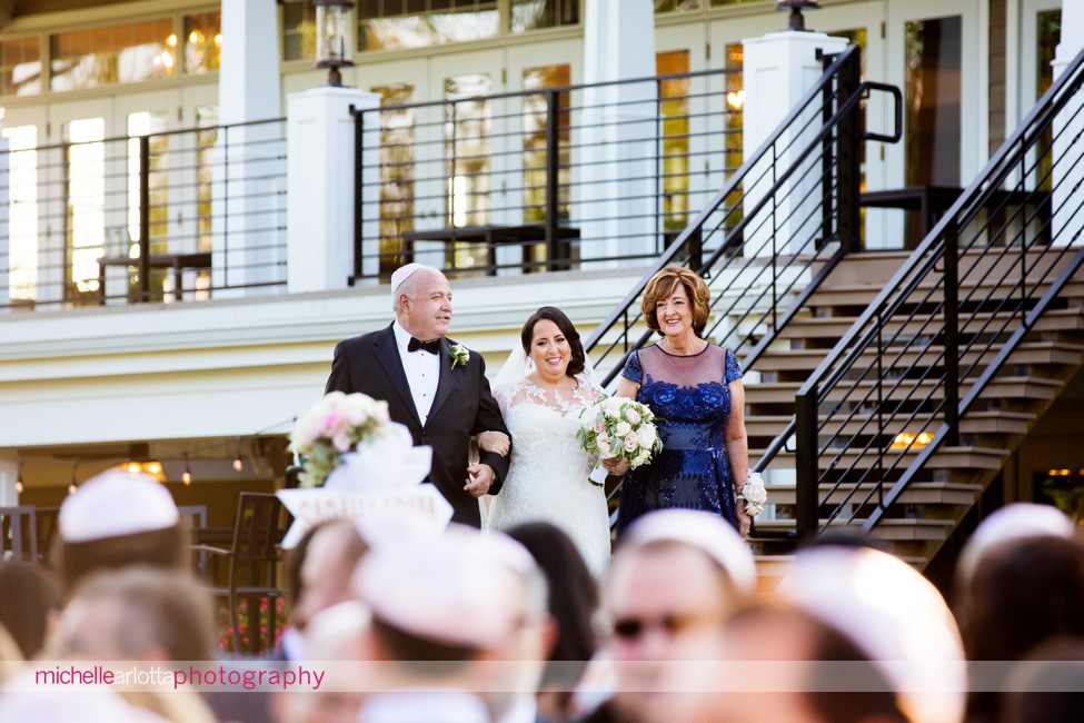 bride and her parents walk down the aisle at nj bear brook valley
