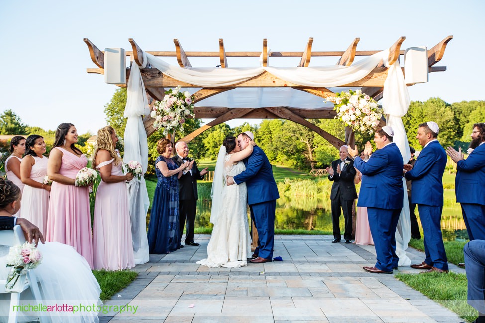 bride and groom kiss at end of bear brook valley summer outdoor wedding ceremony