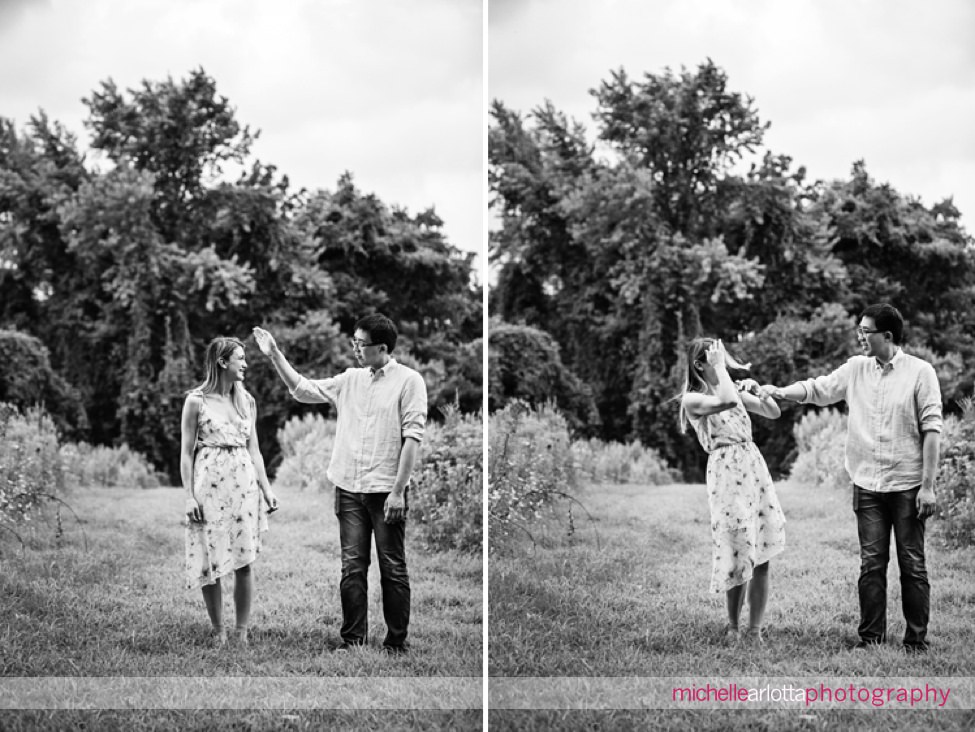 groom smacks at bride's head during mosquito-infested engagement session in New Jersey for engagement session