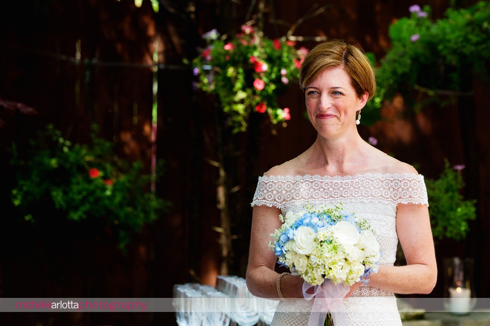 bride walks down aisle in gardens of lbi gables inn intimate wedding New Jersey
