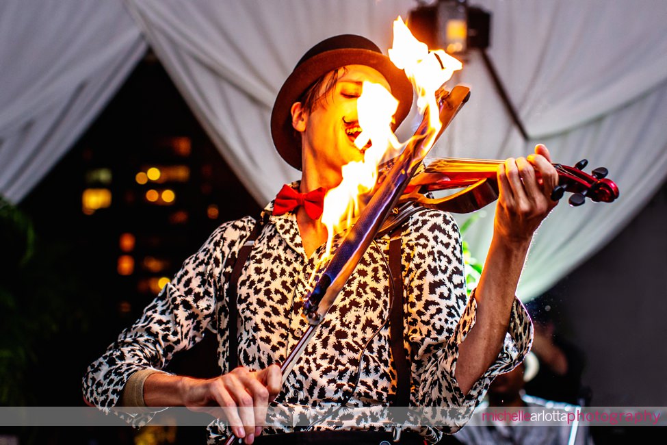 violin Shane performs with flaming bow at swank rooftop nomad hotel nyc engagement party with Central Park orchestra and EnVee