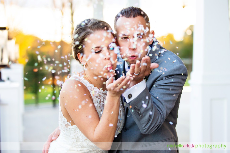 bride and groom blow confetti bear brook valley nj wedding photography