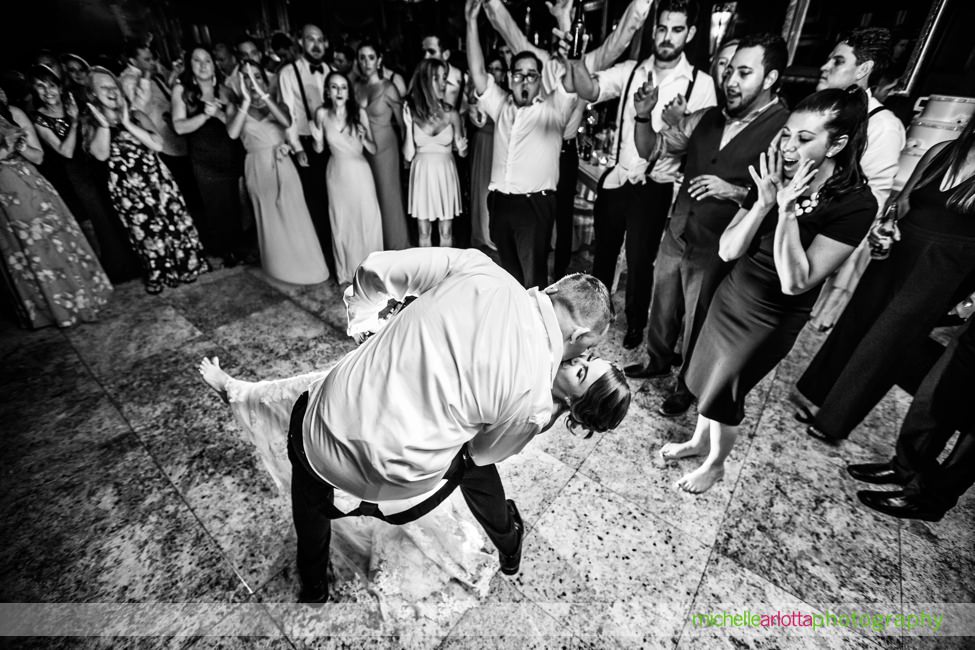 groom dips bride on dancefloor at end of shadowbrook Shrewsbury nj wedding reception