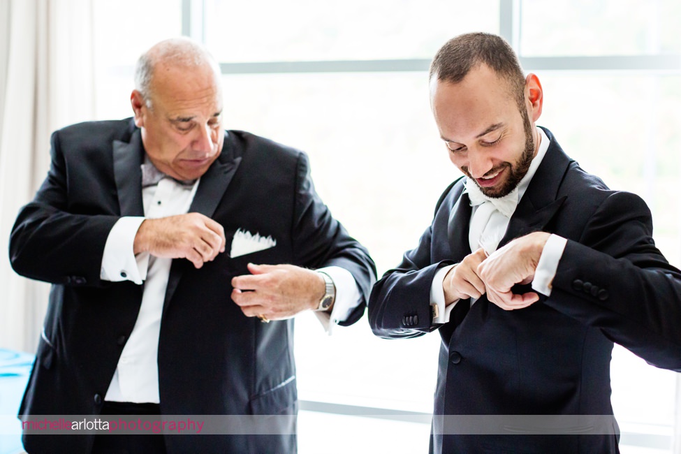 groom and father adjust their pocket squares for stone house New Jersey wedding