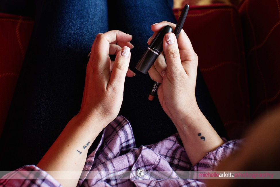 stone house nj wedding bride holding tube of lipstick showing tattoo