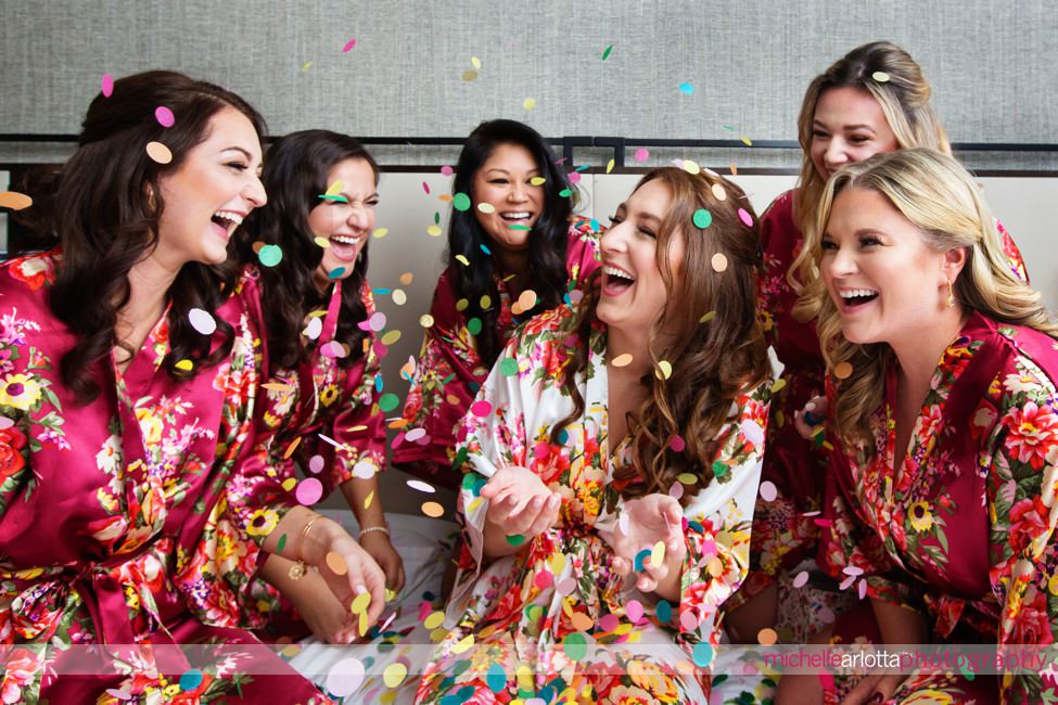 liberty house new jersey bride prep bride and bridesmaids wearing floral robes and throwing confetti