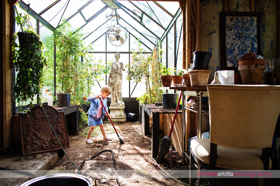 nj family photography little boy sweeping greenhouse