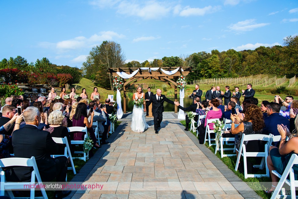 bear brook valley autumn outdoor nj wedding ceremony groom high fiving as he exits