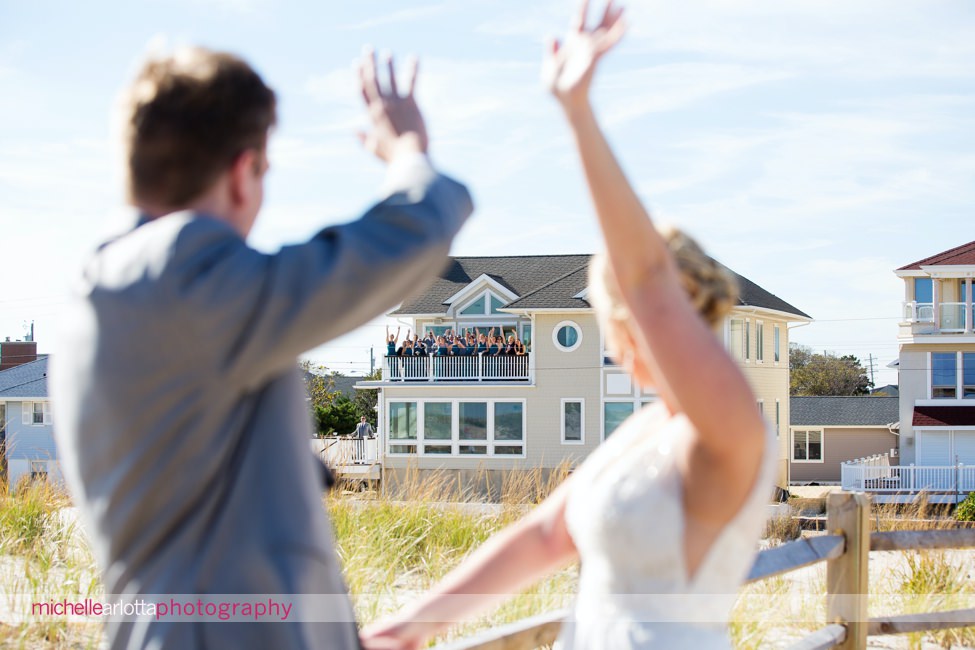 bride and groom wave to bridal party after first look at New Jersey beach