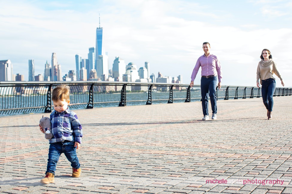 toddler with parents during Hoboken family session nyc skyline