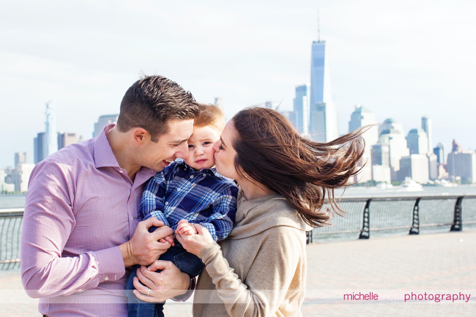 toddler with parents during Hoboken family session nyc skyline