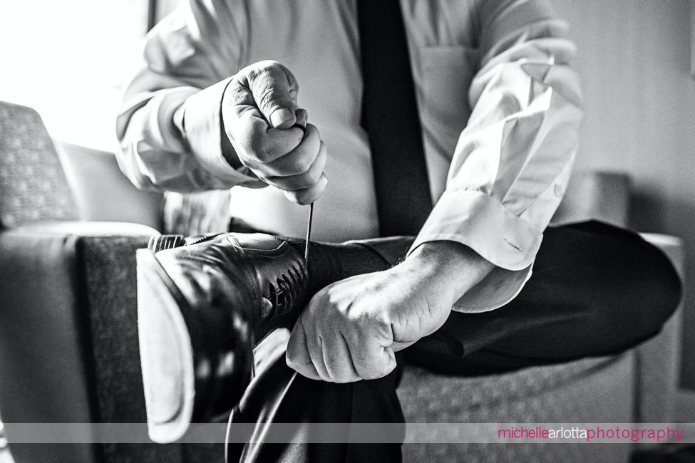 nj wedding Ryland Inn groom tying shoes