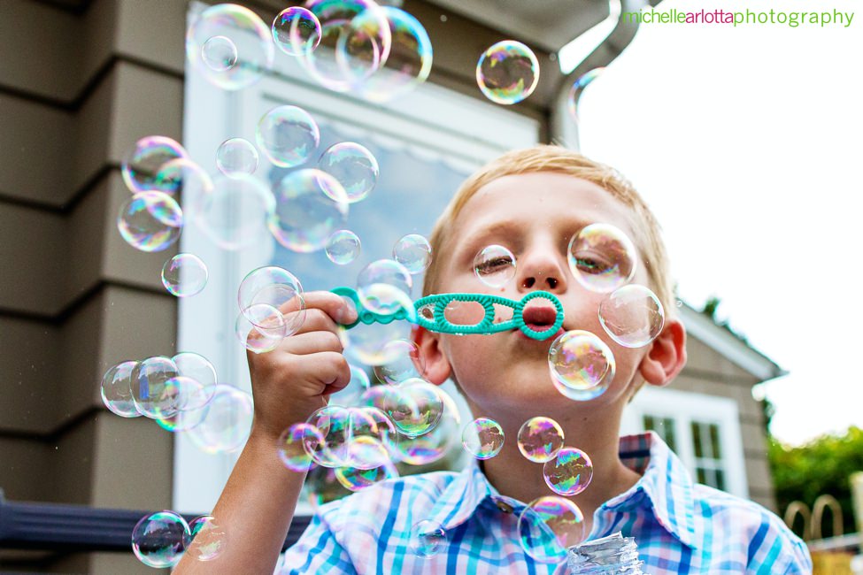 nj backyard microwedding wedding reception boy blowing bubbles