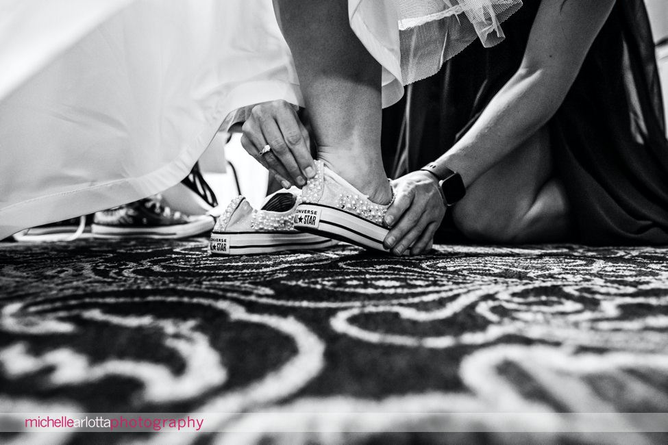 Desmond Hotel Malvern Pa Wedding bride putting on converse sneakers