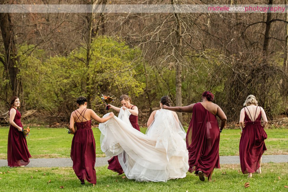 Desmond Hotel Malvern Pennsylvania Wedding bridesmaids holding bride's dress as they walk away