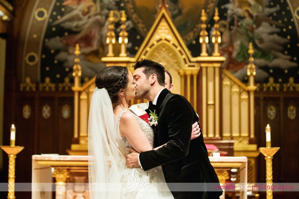 seton hall university chapel NJ winter wedding ceremony kiss