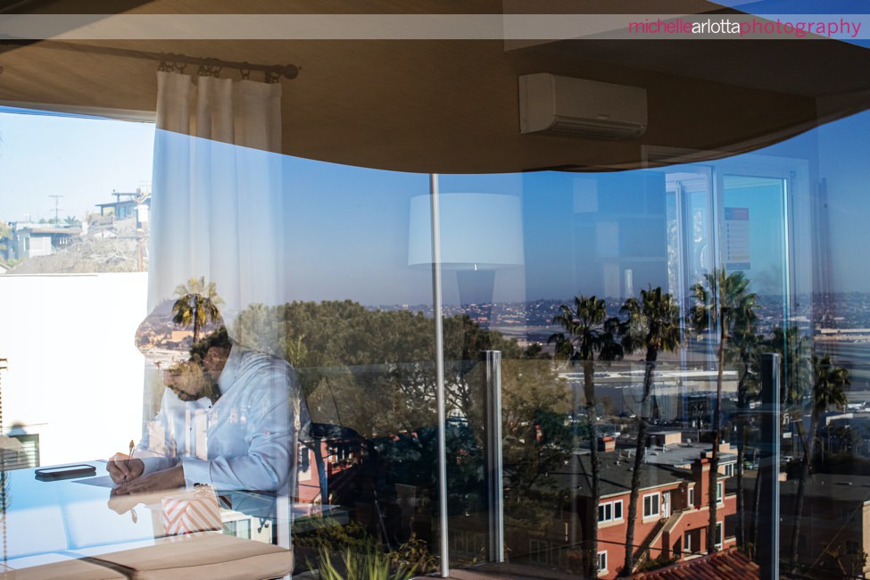 San Diego intimate wedding groom writing vows reflection in window