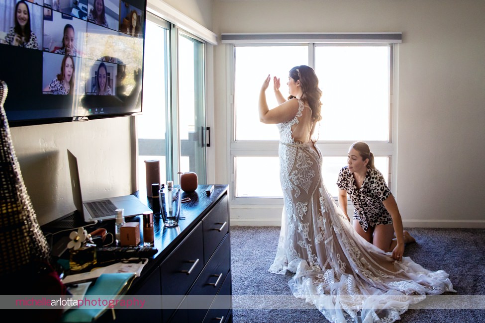San Diego intimate wedding bridesmaids watching on zoom as bride gets in dress