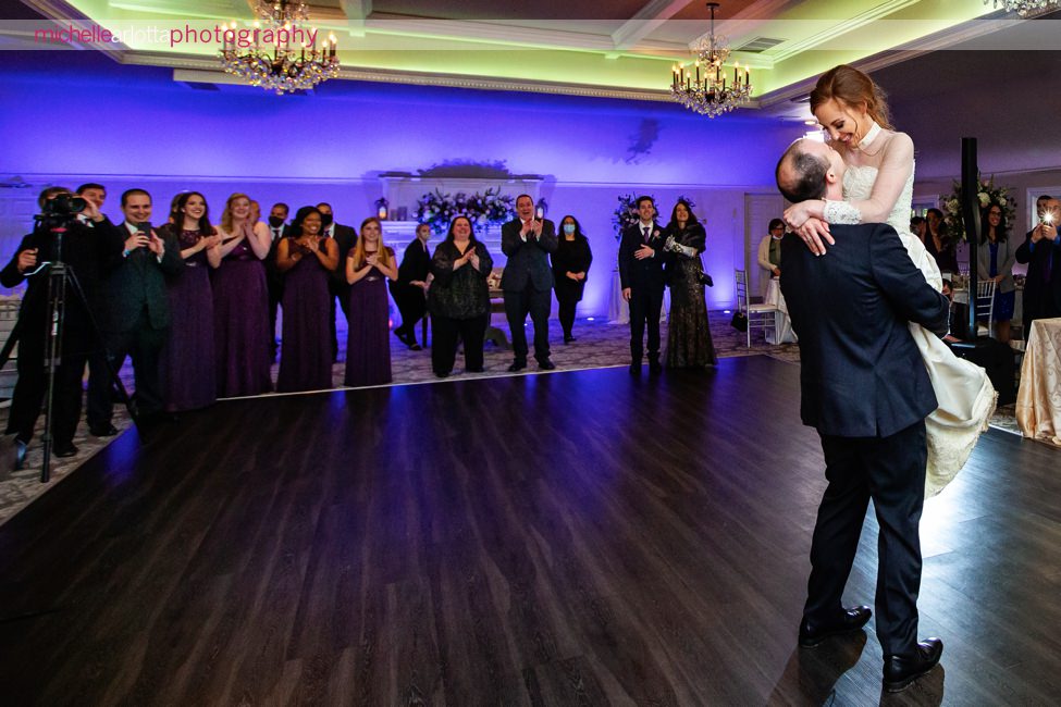 Castle at Skyland's manor wedding reception groom lifts bride up during first dance