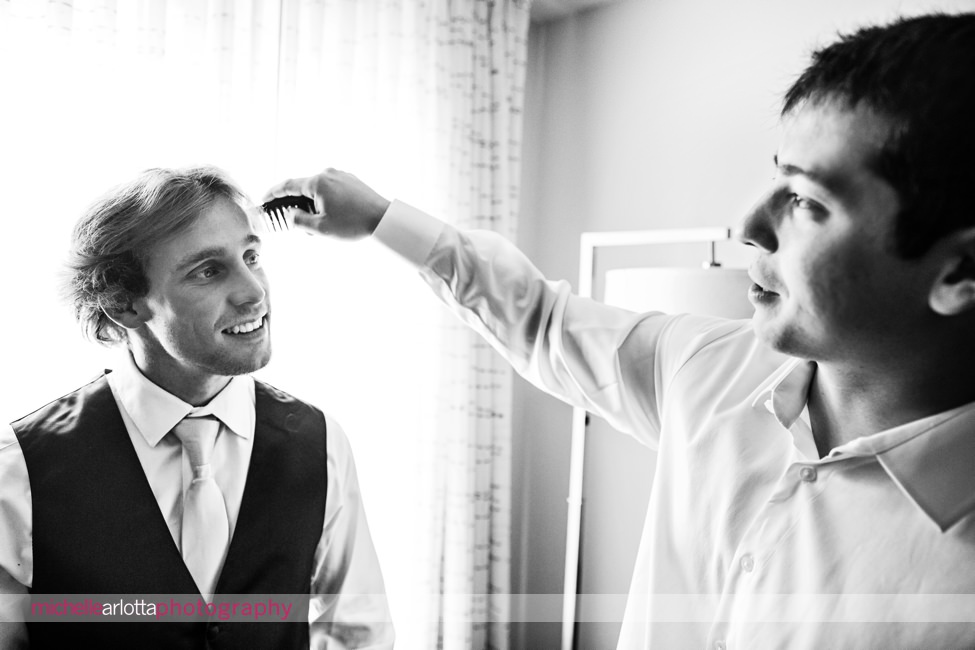 Waterloo village wedding groom combing groomsmen's hair
