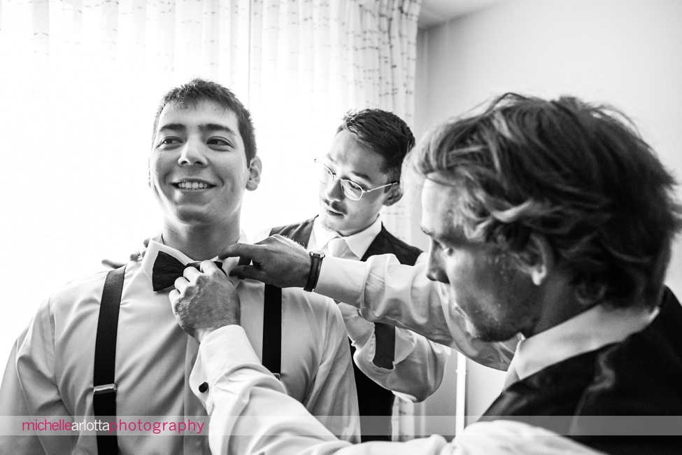 Waterloo village wedding groomsmen helping groom with bowtie