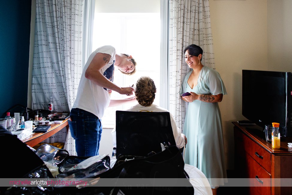 Waterloo village wedding bride getting makeup put on as bridesmaid in mint colored dress watches