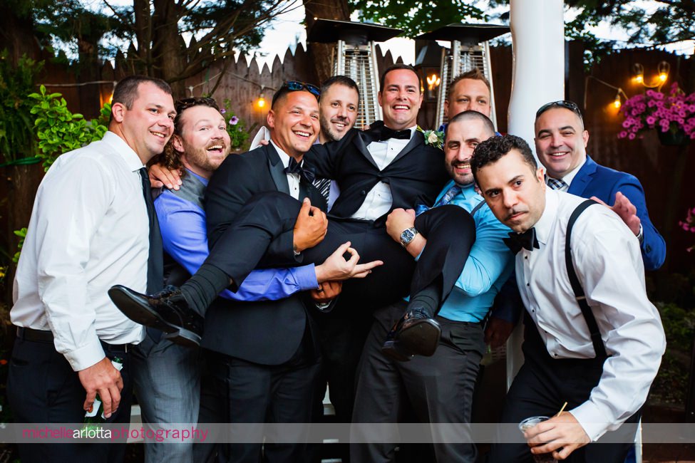 The Gables LBI summer wedding reception beach haven, NJ wedding guests lifting up the groom