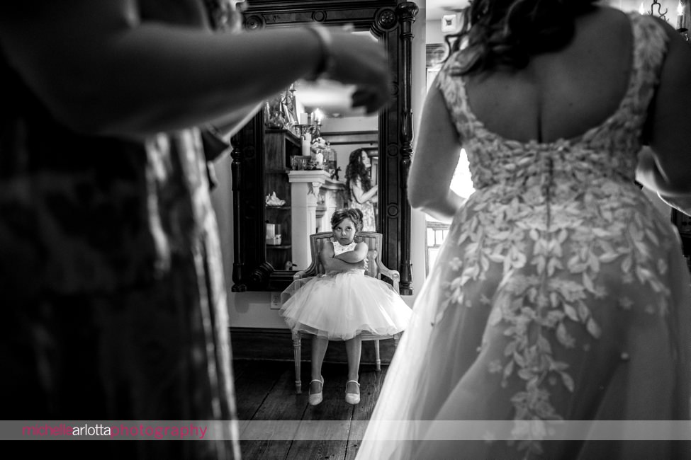LBI NJ wedding flower girl watching as bride gets into dress
