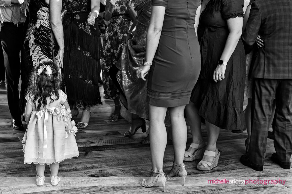 The Farmhouse wedding new jersey wedding reception flower girl stands amongst the tall guests