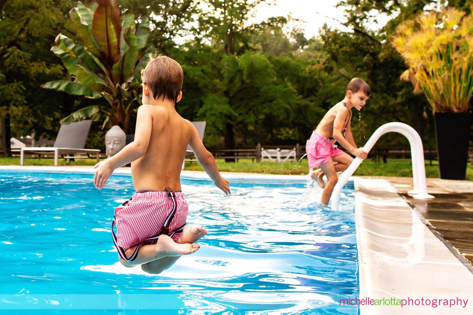 NJ candid family photography brothers jumping in the pool