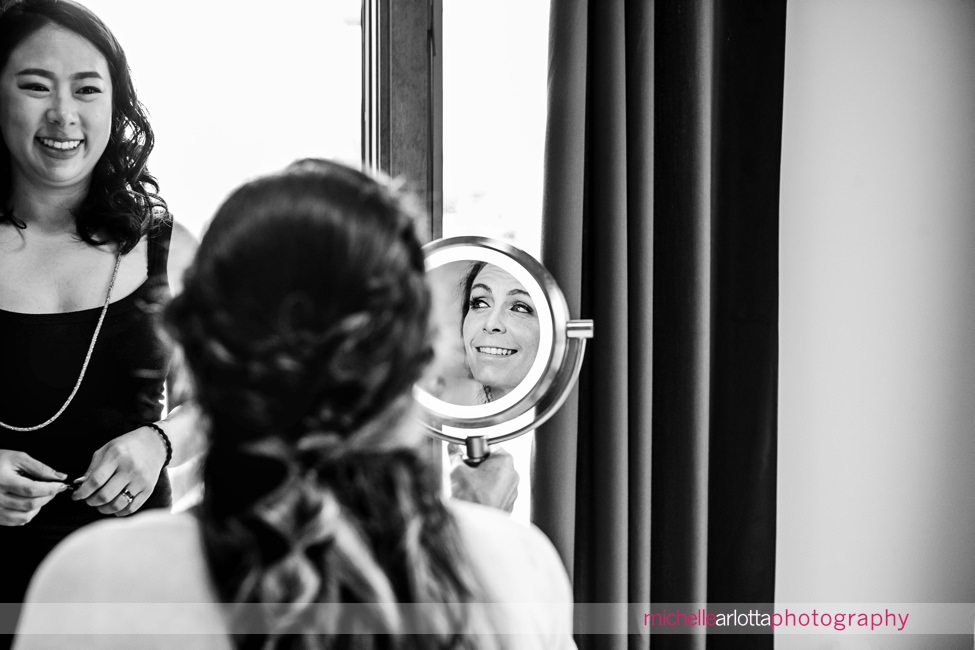 Long Beach Island NJ wedding bride prep bride looks in mirror at makeup