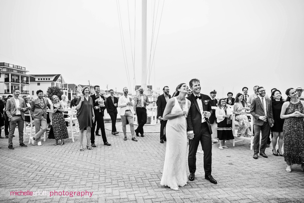 Brant Beach yacht Club LBI NJ wedding reception bride and groom laughing listening to toasts outside