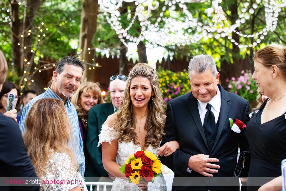 Gables LBI Fall same sex wedding outdoor ceremony NJ bride crying as she walks down altar