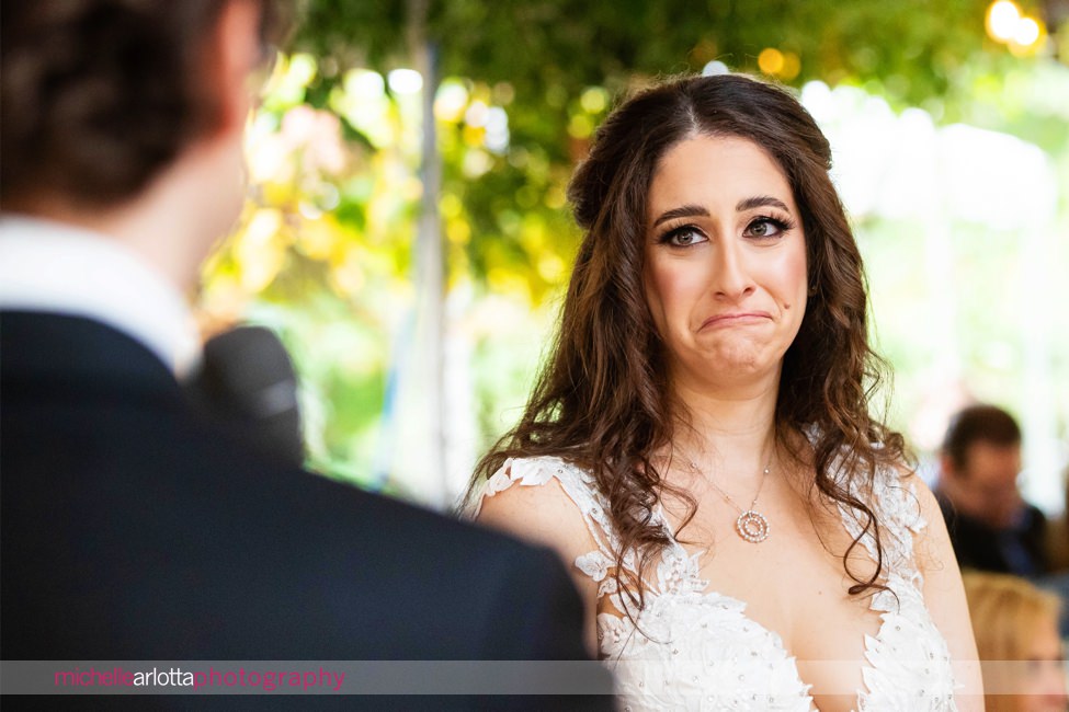 New Jersey backyard wedding tented ceremony bride reacts as groom reads vows