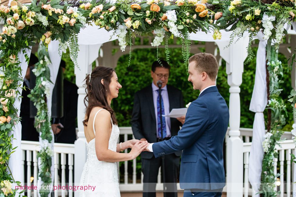 The Farmhouse NJ outdoor spring wedding ceremony ring exchange in front of gazebo