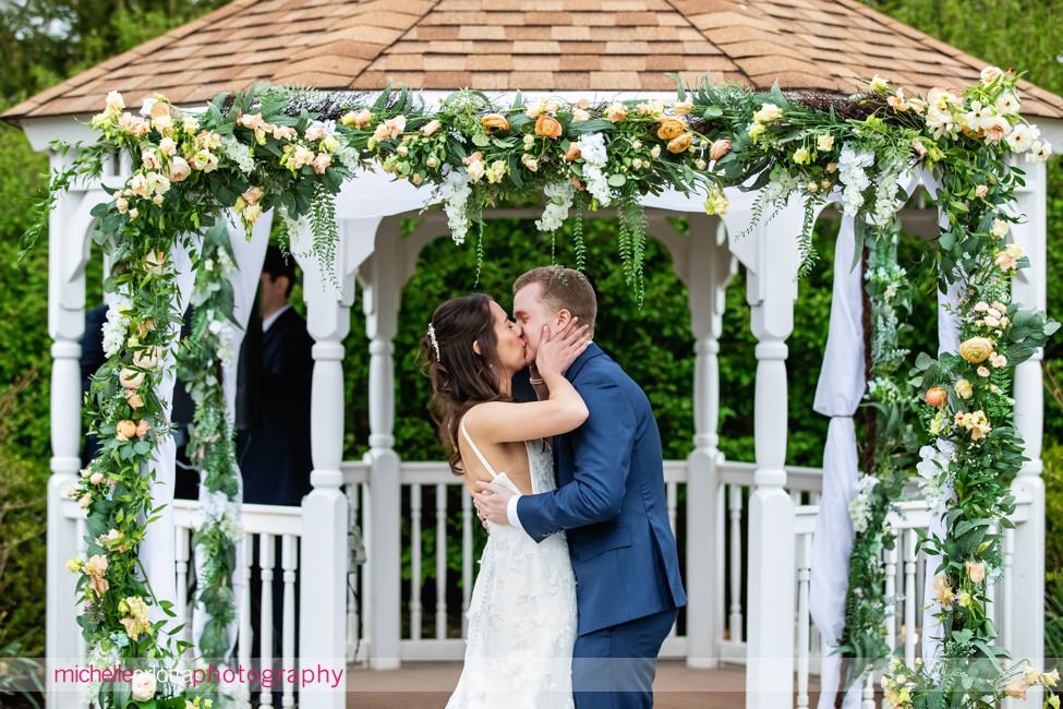 Landmark Venues The Farmhouse NJ outdoor spring wedding ceremony kiss