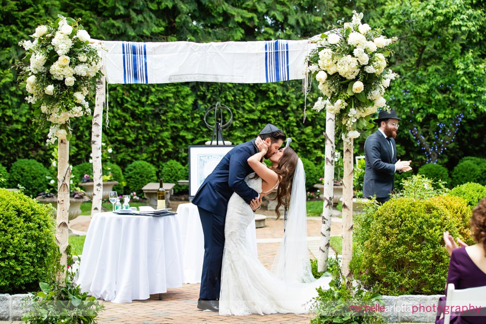 outdoor NJ wedding ceremony at Florentine Gardens bride and groom kiss