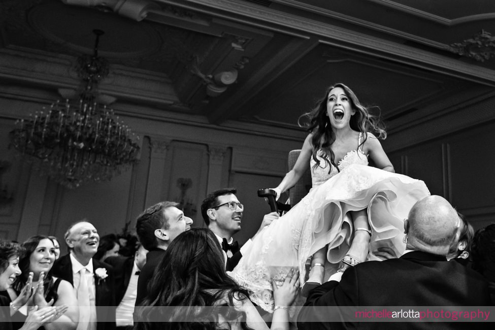 estate at Florentine Gardens nj wedding reception bride up in the air during the horah