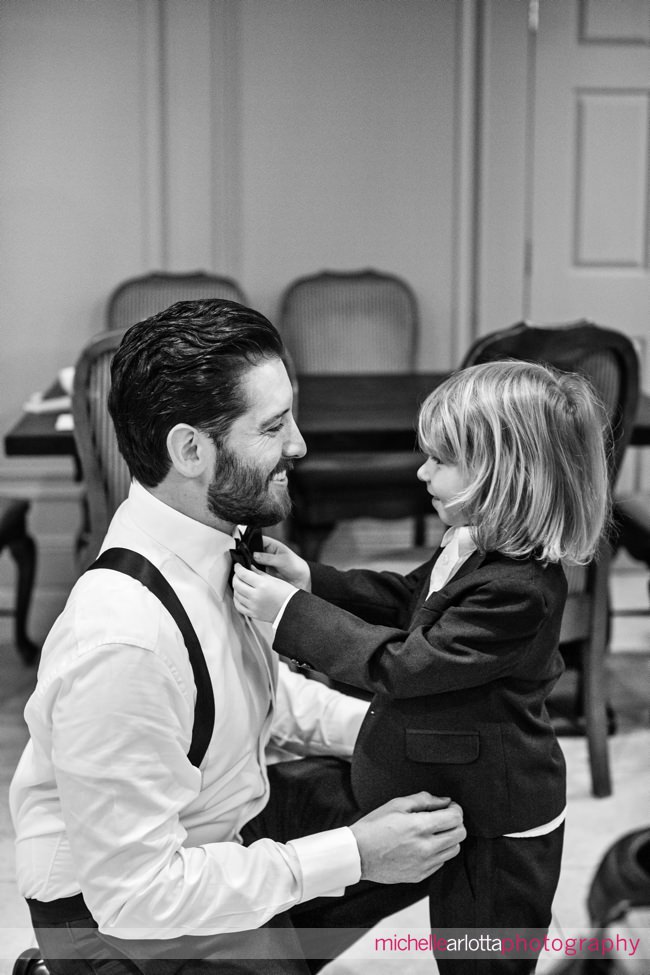 ring bearer and groom during prep at New Jersey wedding
