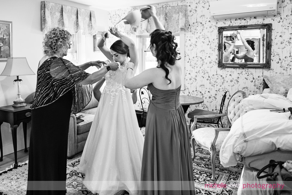 North Shore House NJ bride tosses her bra as she gets in her dress