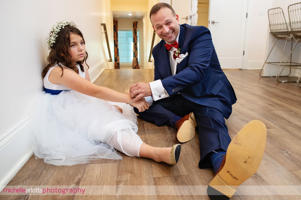 winery wedding groom helps stepdaughter with bracelet