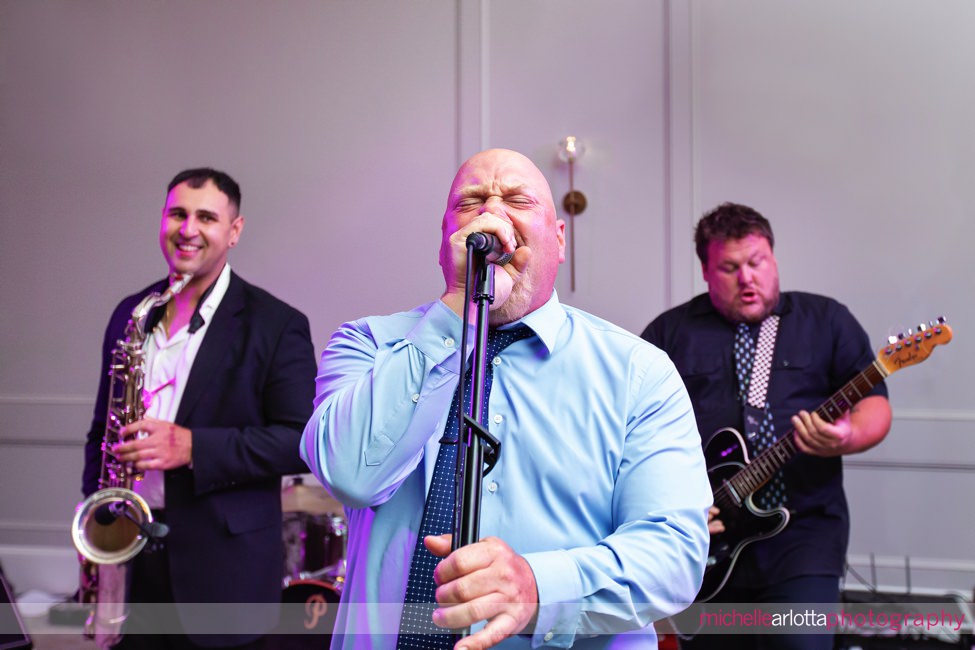 Renault Winery wedding reception champagne ballroom wedding guest singing on the microphone with The Pickles