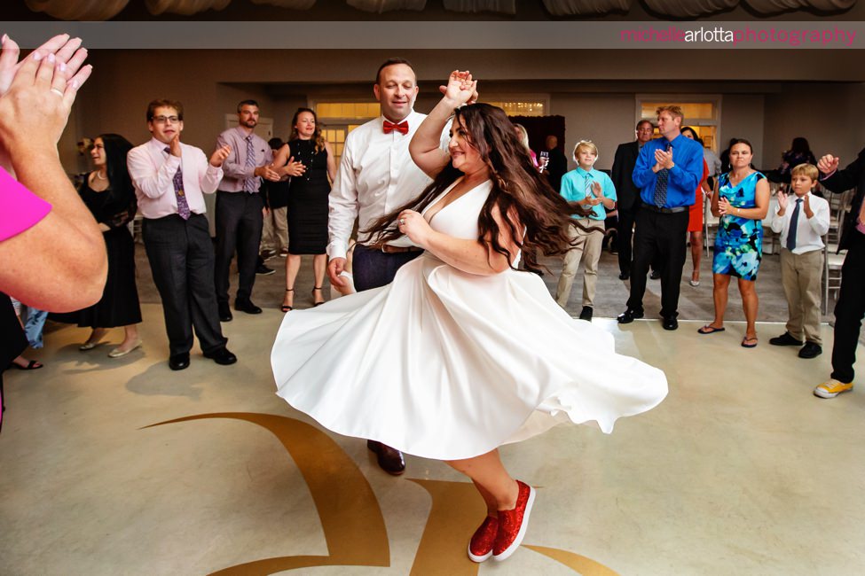 Renault Winery wedding reception champagne ballroom bride twirling around with ruby red glitter sneakers