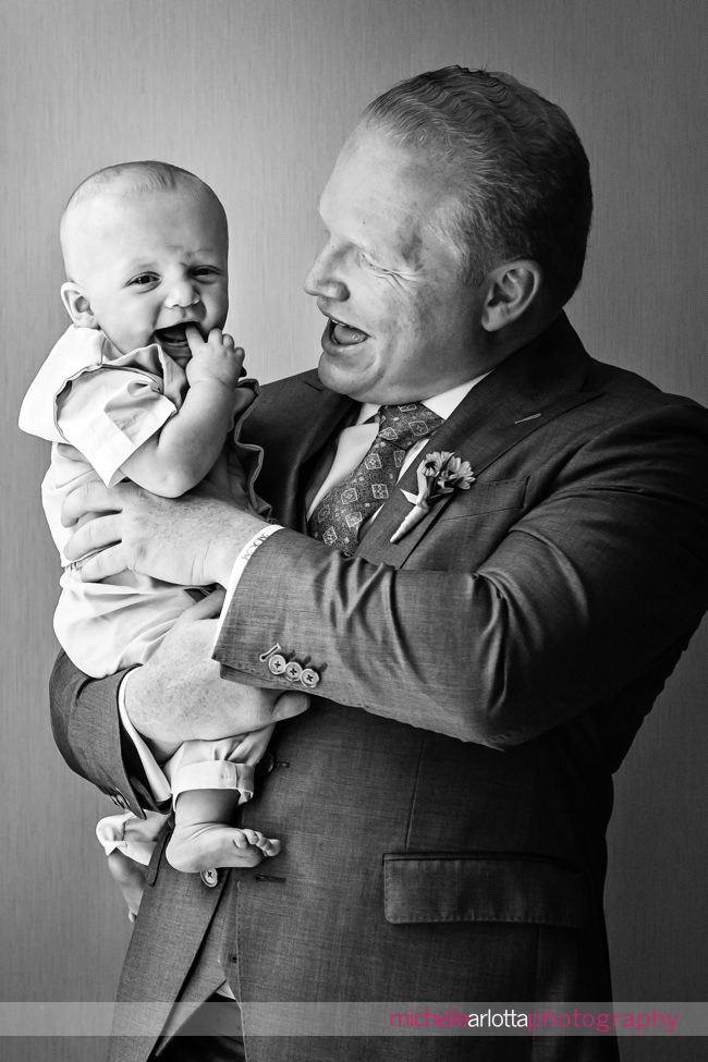 Groom portrait with infant son for New Jersey wedding