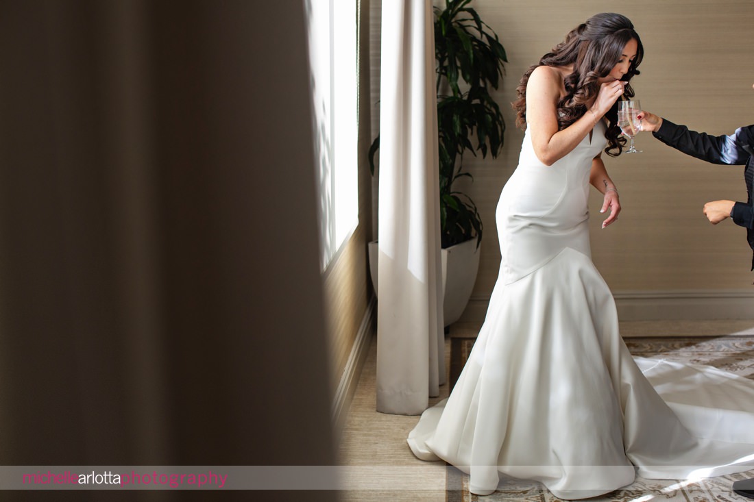 Edgewood Country Club wedding NJ bride takes a sip of a drink between portraits