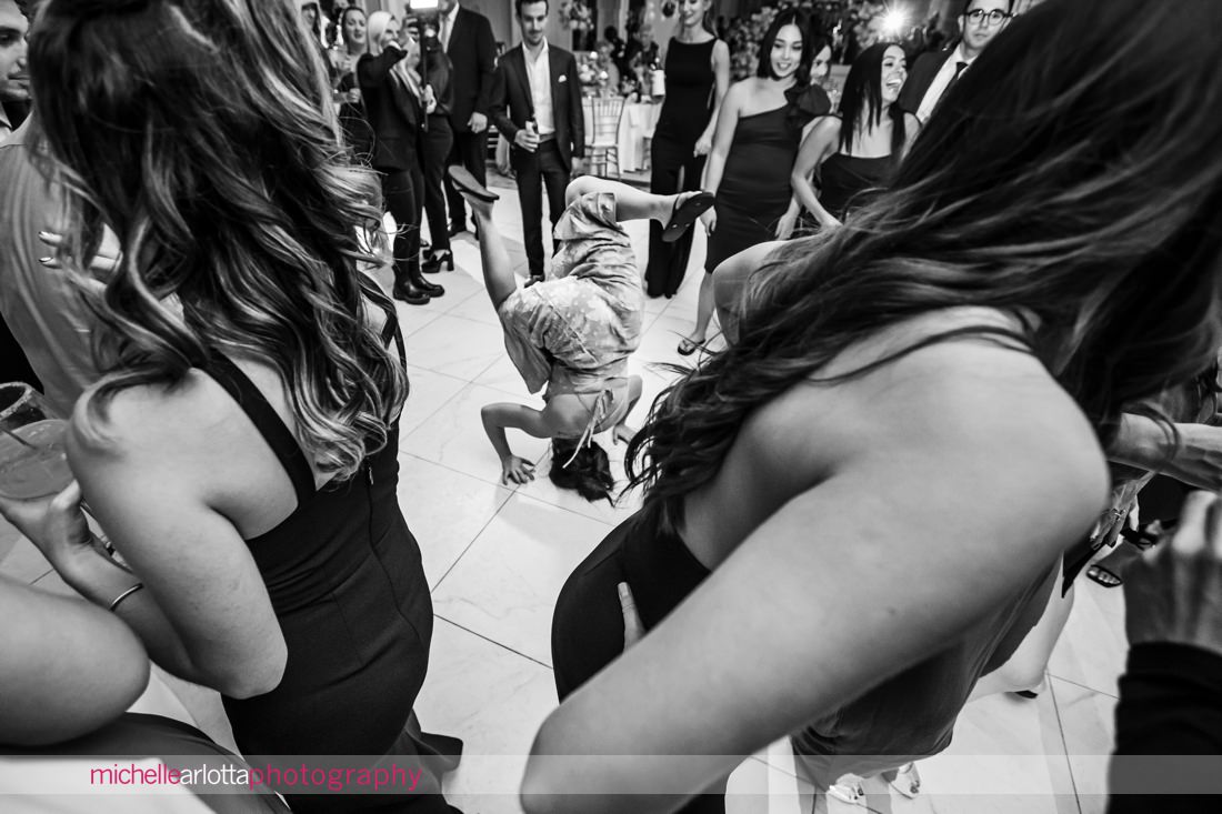 New Jersey wedding reception girl doing a headspin on the dancefloor